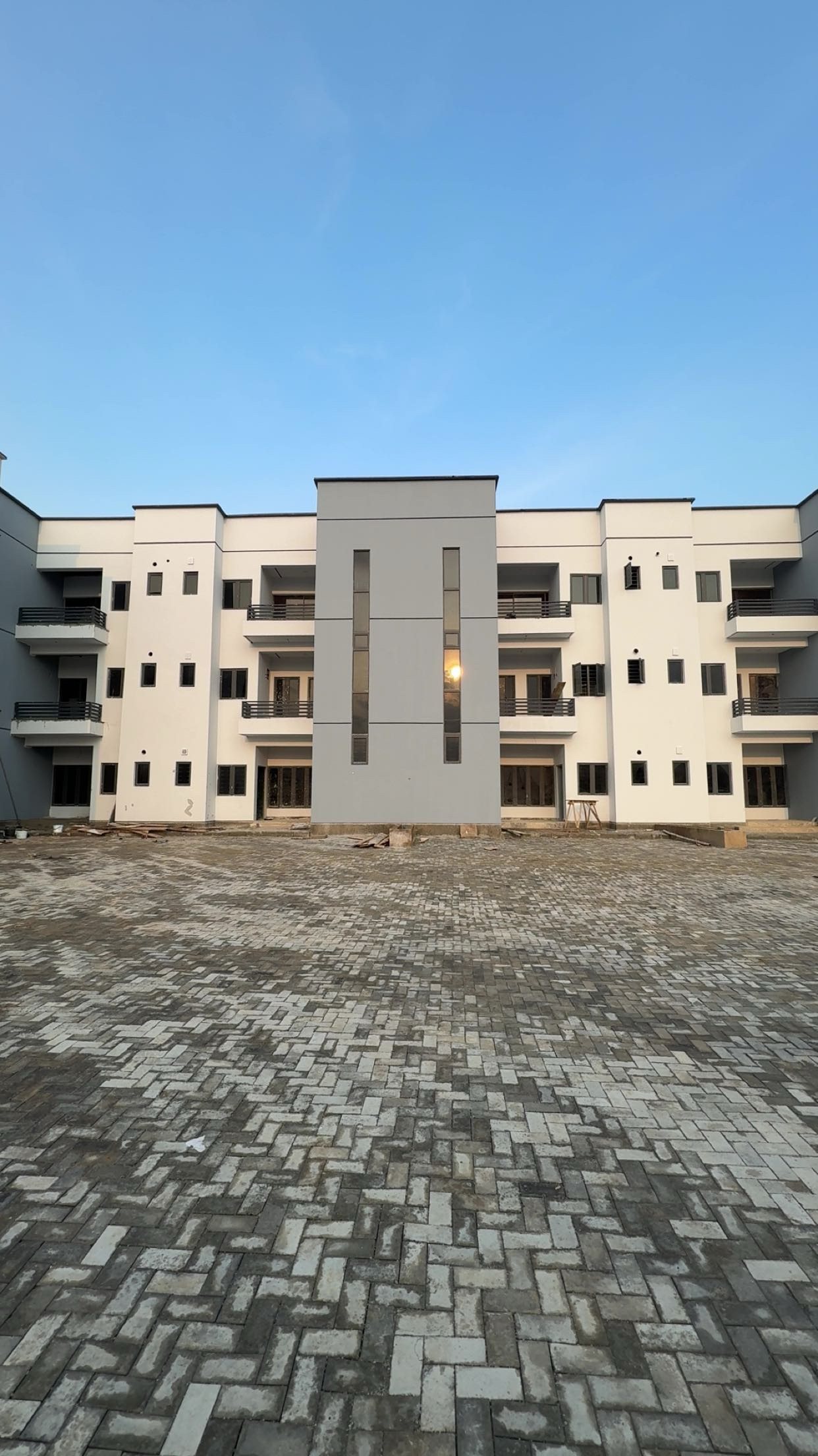 Paved courtyard in front of the completed blocks at Belleville Estate