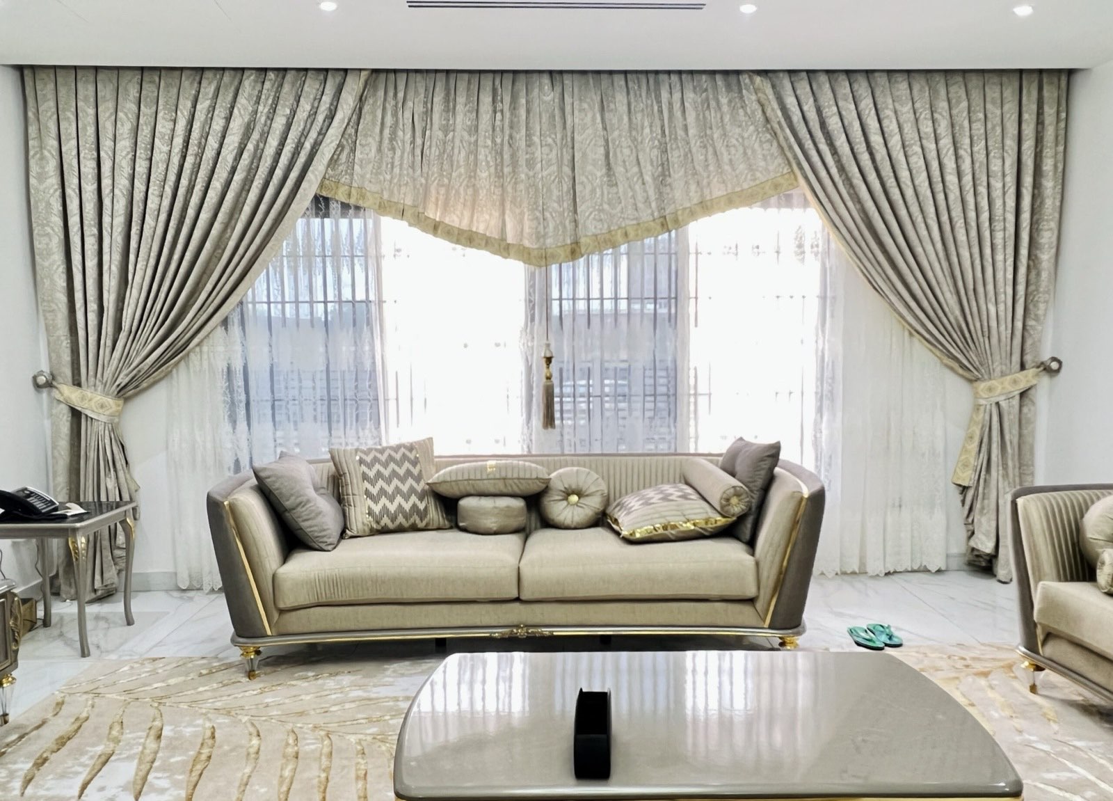 Remodelled living room of the Stone House with full-height curtains