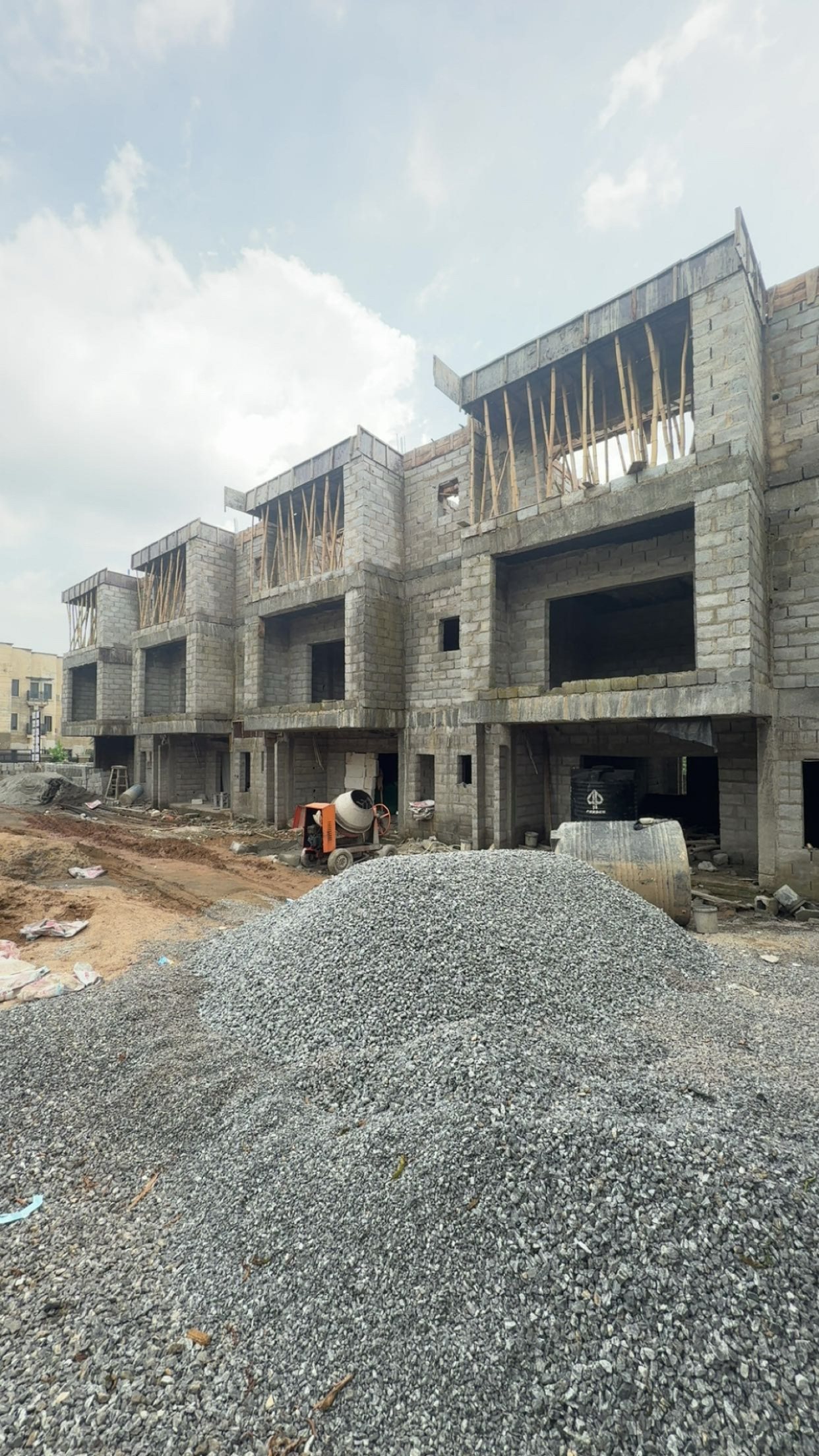 Terrace shells under construction at The Axis with aggregate stockpiled